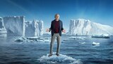 Key art for Season 12 of Curb Your Enthusiasm: Larry David stands on a small ice floe in the ocean, shrugging, surrounded by icebergs under a clear blue sky.